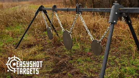 steel shooting targets lined up and hung at an outdoor shooting range