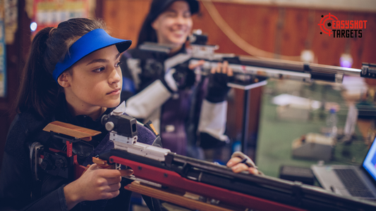 Two ladies holding guns