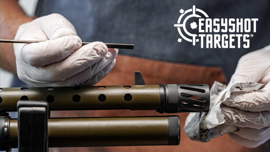 man cleaning barrel of gun