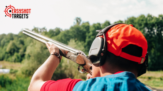 A man pointing a rifle at the sky at the shooting range