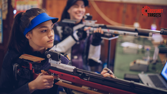 Two ladies holding guns 