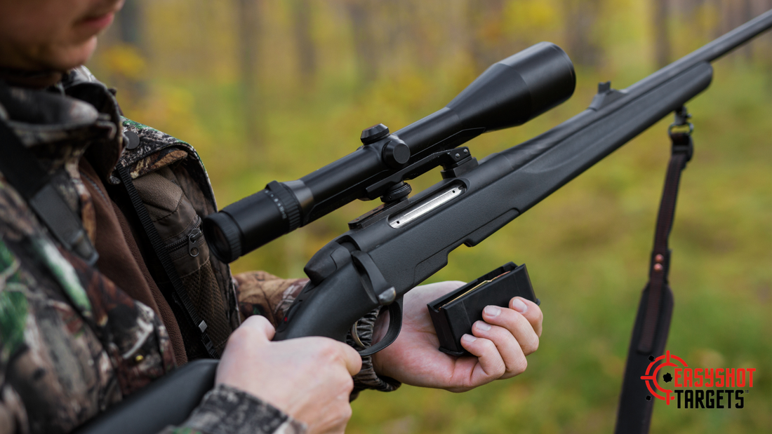 A man in military wear holding a rifle out in the bush