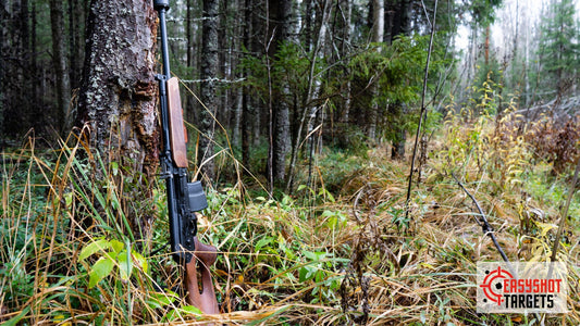 A rifle leaning against a tree in the forest