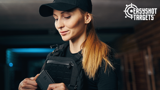 woman inspecting equipment in hand at shooting range